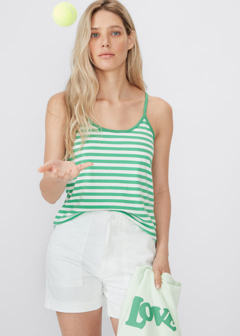 Model wearing the Spaghetti Tank in green/white with the City short in white