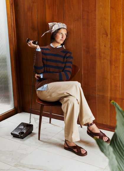Model sitting in a chair wearing The Tatum - Brown/Navy