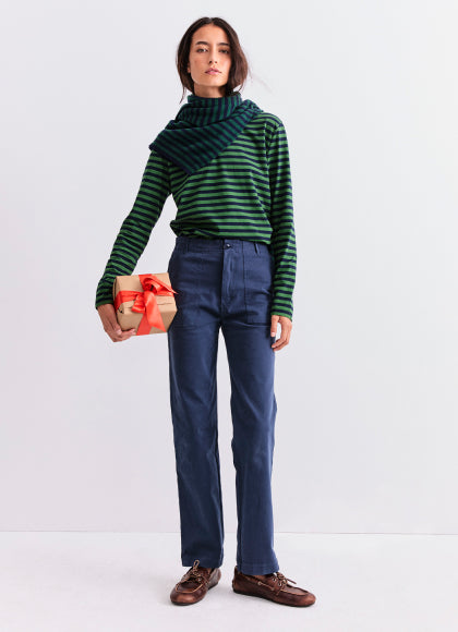 Model wearing The Modern Long - Navy/Green while holding a present