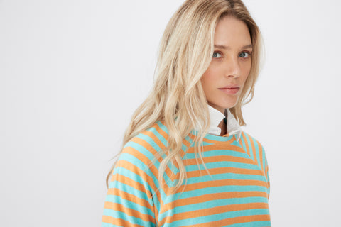 Model wearing the Terry Franny in Sherbert/Aqua with a white collared shirt peaking out in the neckline