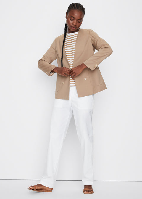 Model wearing the Nelson blazer in khaki with the modern tee in white/beige stripe and city pant in white